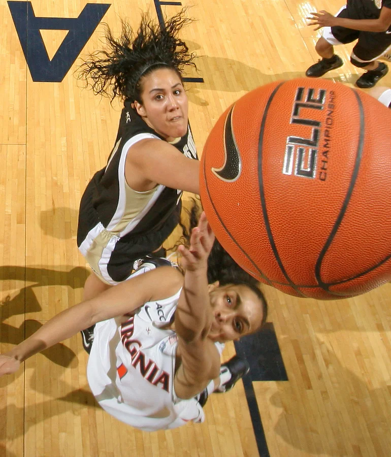 Feb. 3, 2011; Charlottesville, VA, USA; Virginia Cavaliers guard China Crosby (1) is defended by Wake Forest Demon Deacons forward Sandra Garcia (21) as she makes a basket during the game at the John Paul Jones Arena. Virginia won 73-46. Mandatory Credit: Andrew Shurtleff