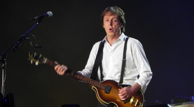 Paul McCartney playing at concert