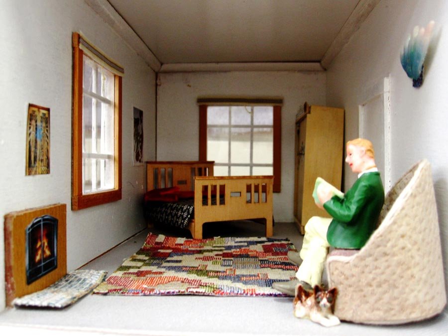 Dollhouse man in a dollhouse bedroom