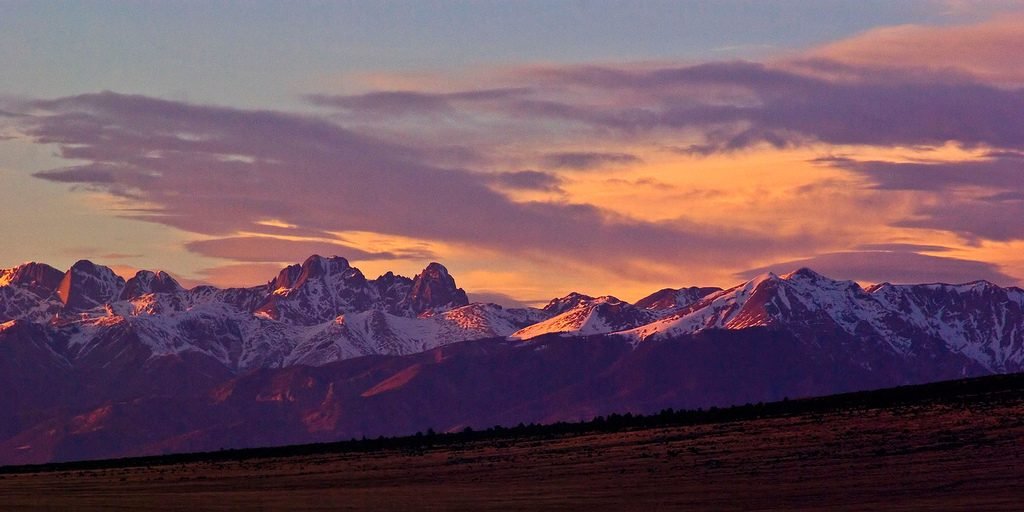 Sunset over snow-capped Rocky Mountains