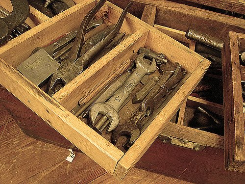 Wooden toolbox full of tools