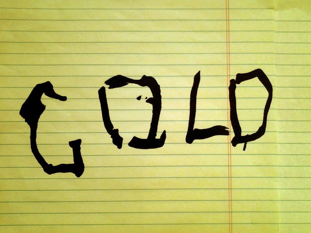 the word gold written on paper