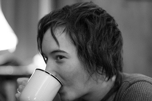 Person drinking from mug
