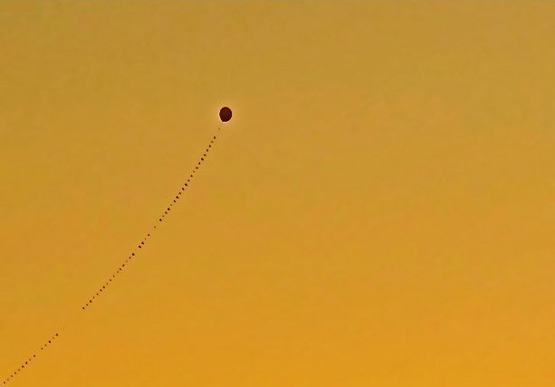 Lone balloon high in the sky