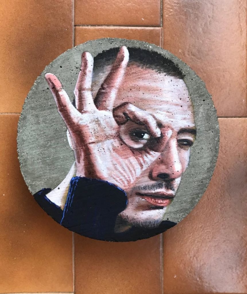 Painting of man looking through circle made by his fingers