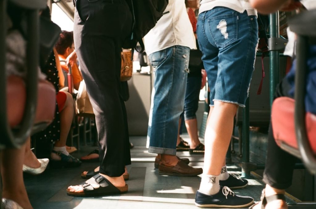 Photo of legs of people in a subway car