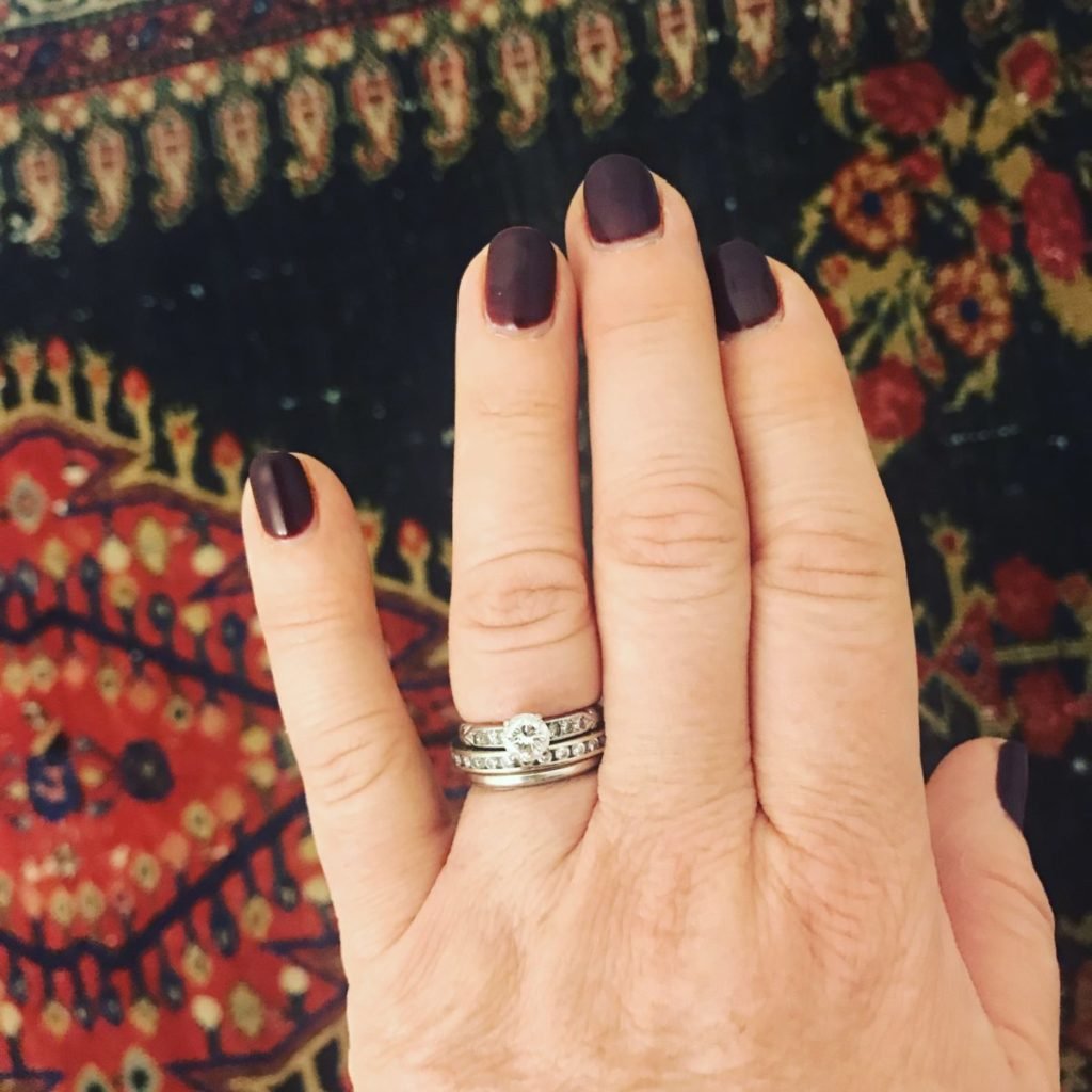 Photo of hand with wedding rings on ring finger