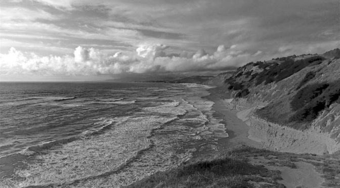 Black and white photo of Pacific Ocean meeting land