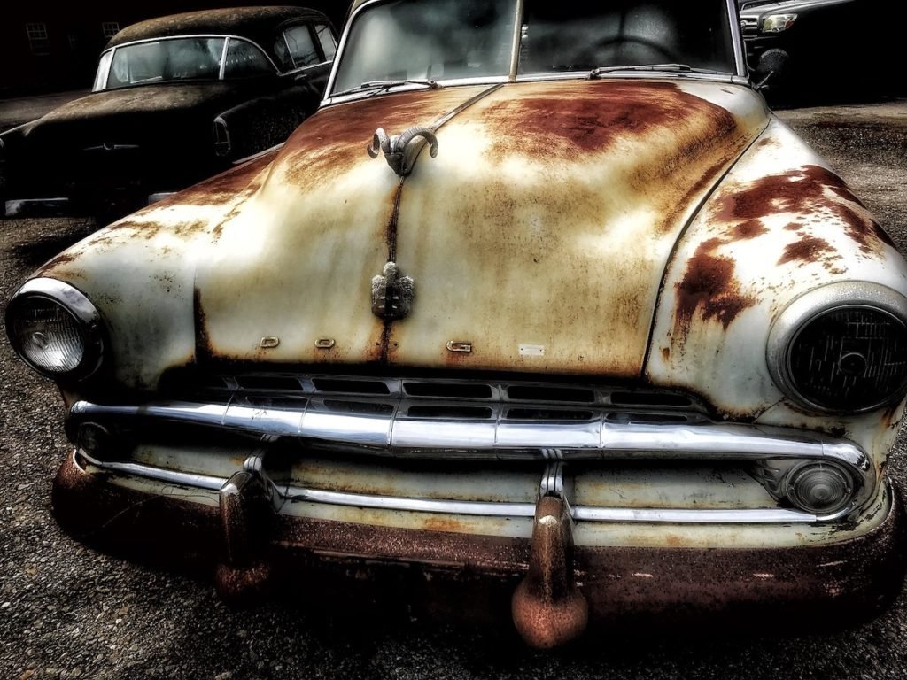 Photo of white, rusty old Dodge