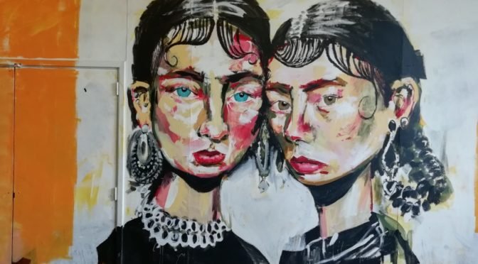 Photo of painting of two women on wall