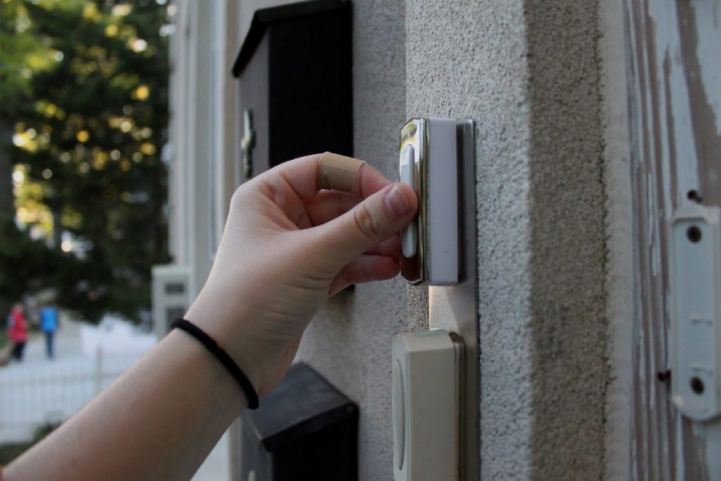 Photo of hand ringing doorbell