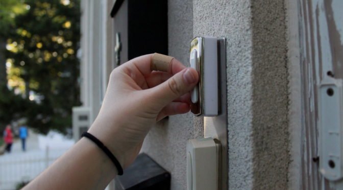 Photo of hand ringing doorbell