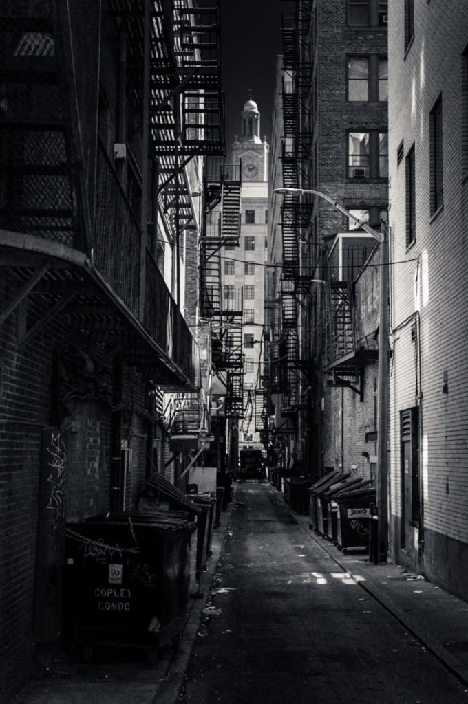 Black and white photo through an alley