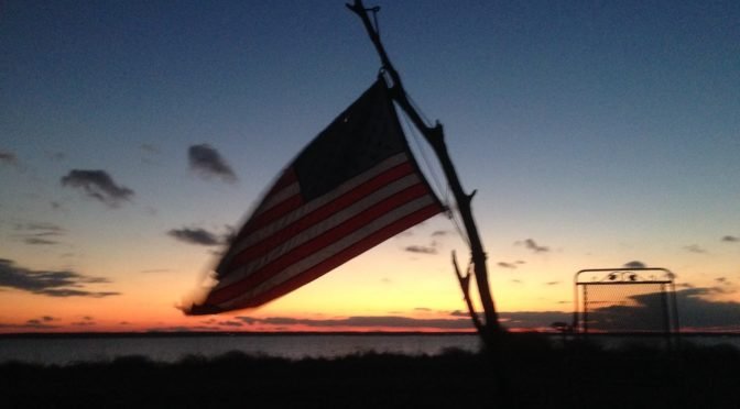 Picture of American flag overlooking river