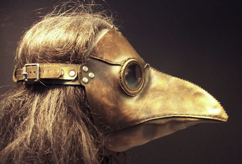 Profile view of woman wearing plague mask