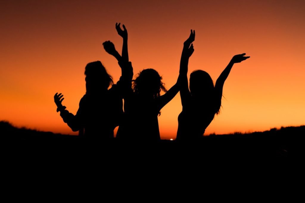 Silhouettes of women against sunset