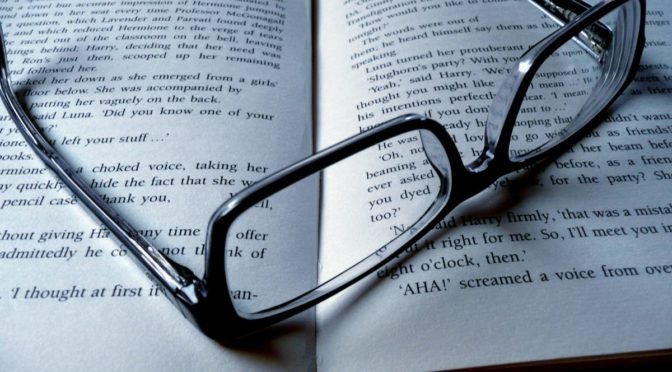 Photo of glasses sitting on open book