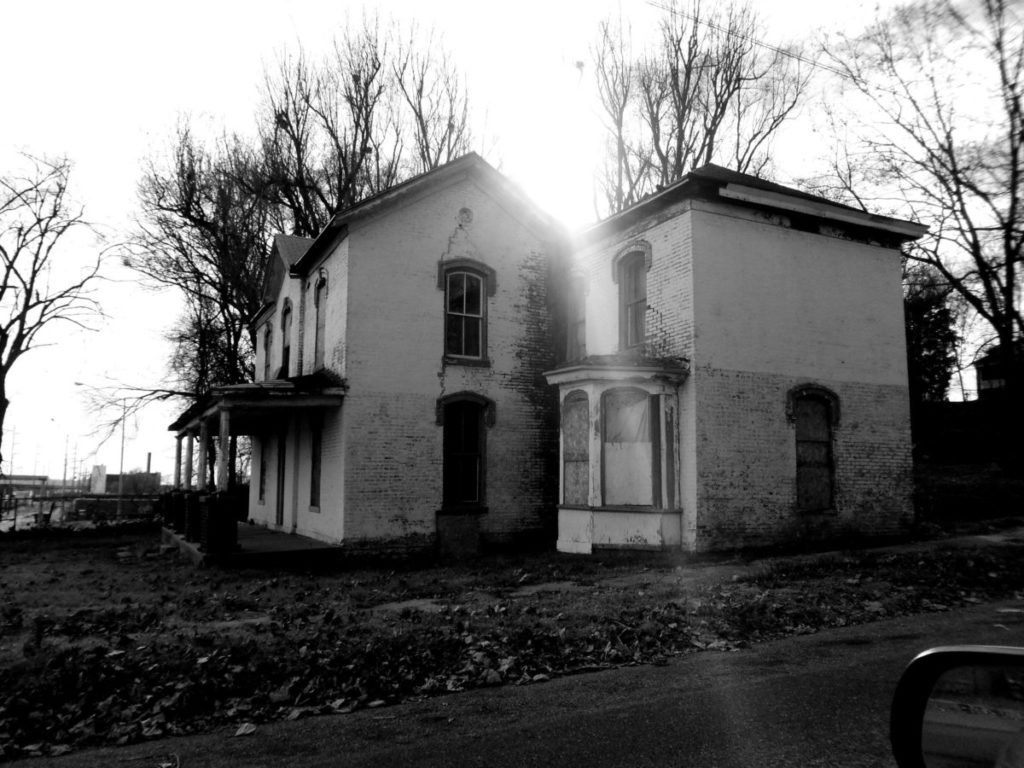 Photo of old house with light shining over it