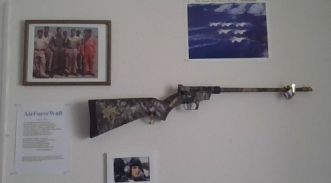 Photo of gun and pictures on wall