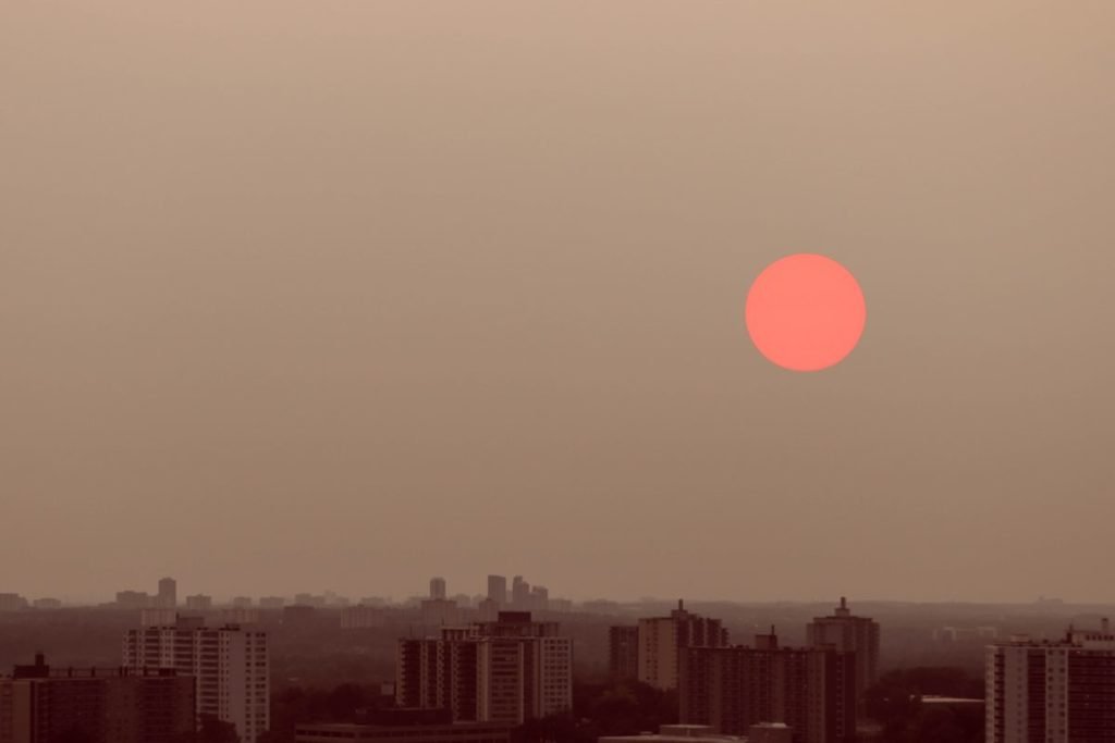 Photo of red sun above skyline