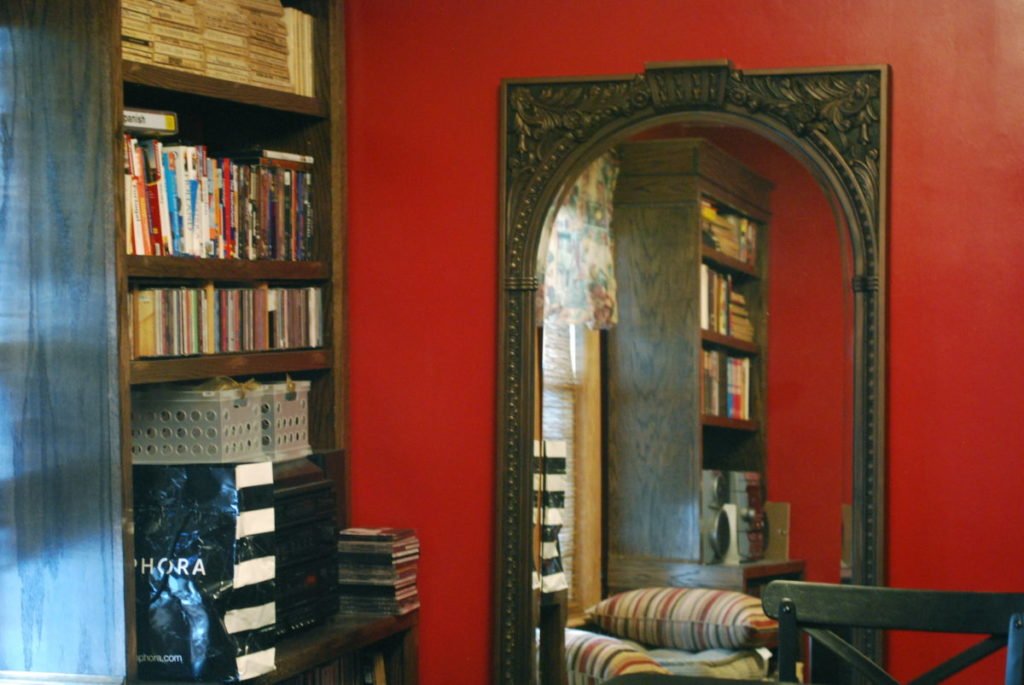 Picture of mirror by bookcase
