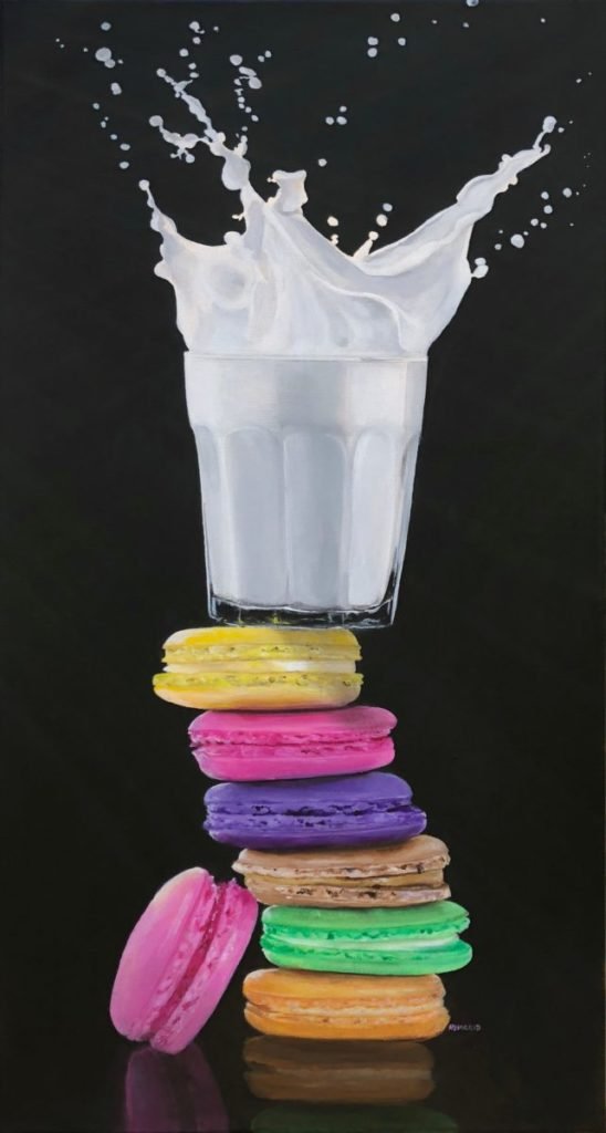 Painting of glass of milk atop stack of macarons