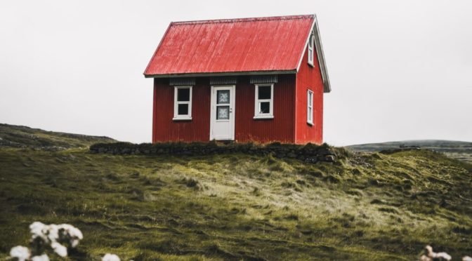 Photo of red house on top of hill