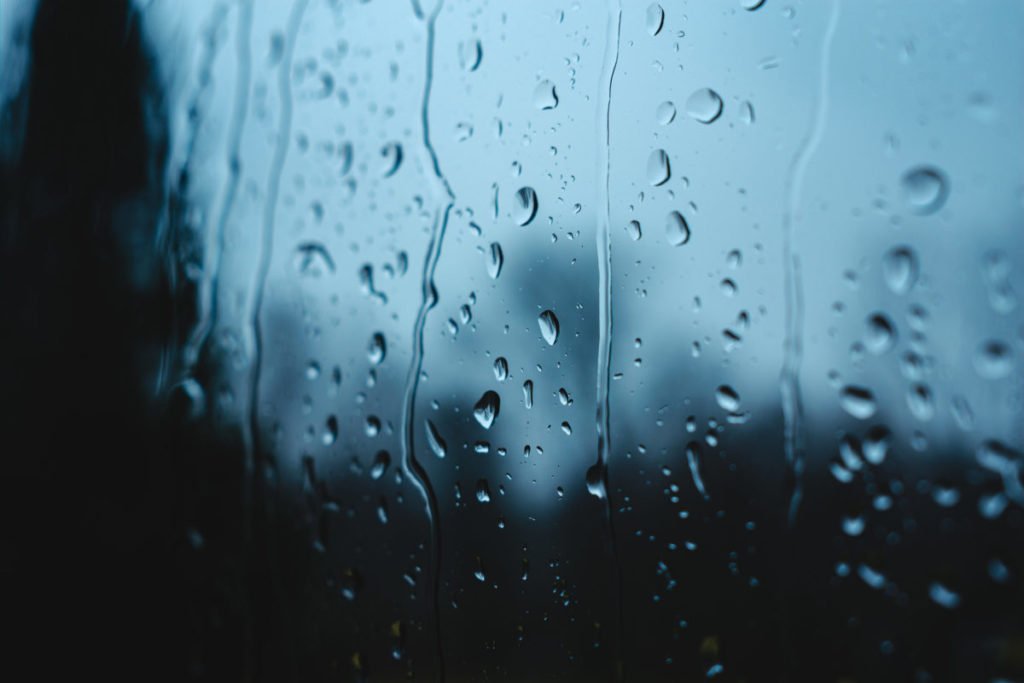 Rain drops sliding down window