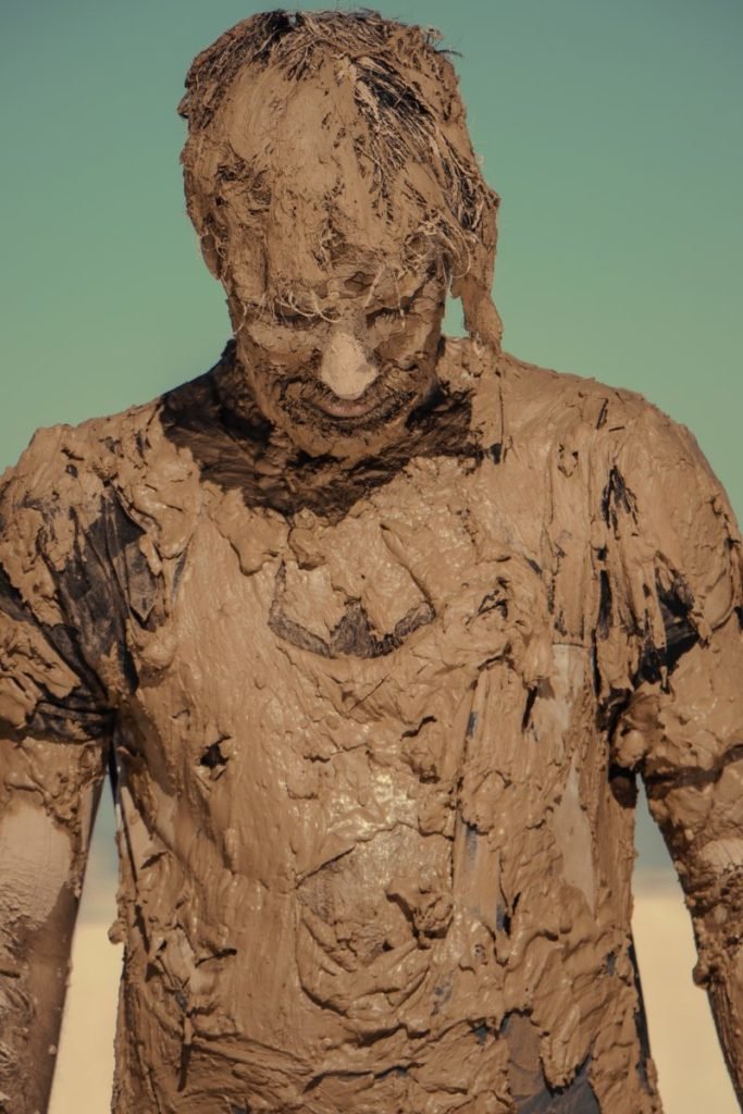 Photo of person covered in mud