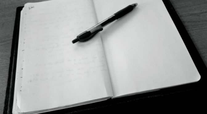 Photo of pen on open notebook