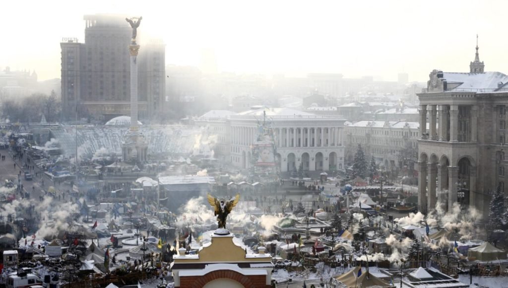aerial view of smoky city, protestors