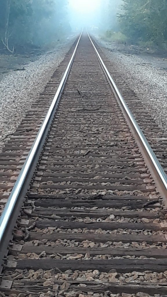 railroad tracks, fog at the end
