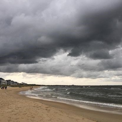 Photo of beach under dark clouds