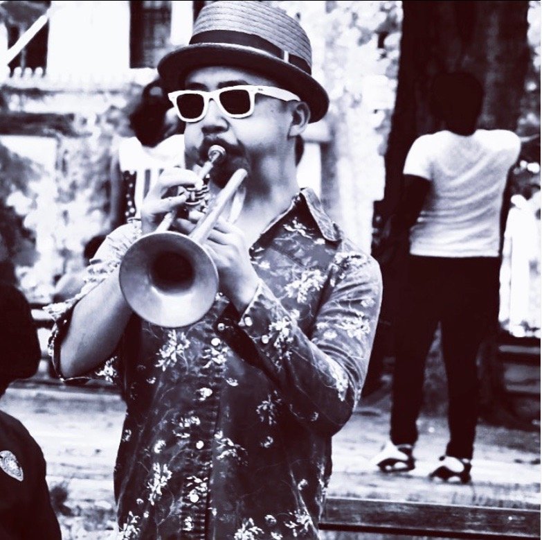Black and white photo of man playing trumpet