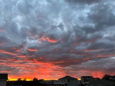 Photo of sunset behind clouds