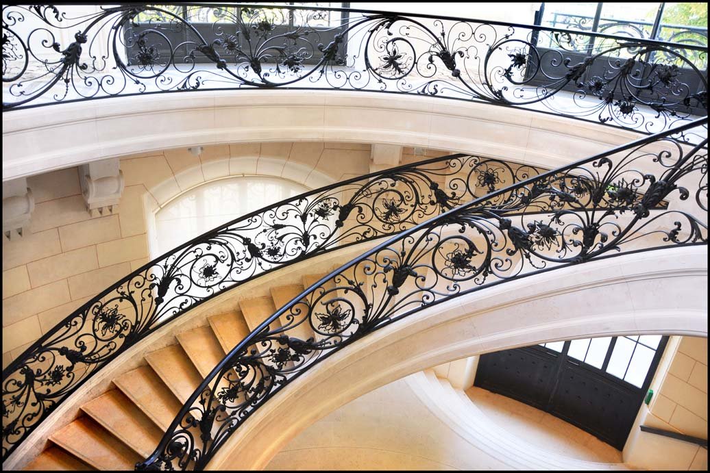 Photo of winding staircase with filigree railing