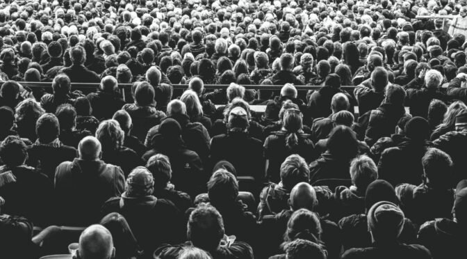 Black and white photo of concert audience from the back
