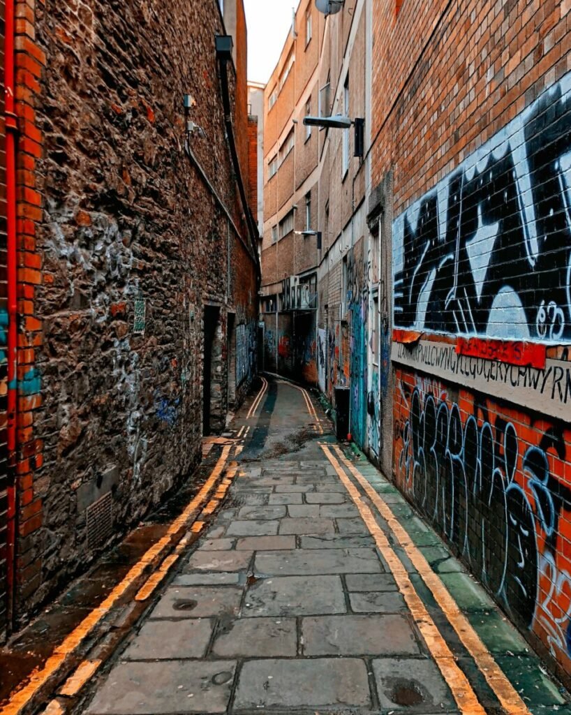 Photo of alley between brick buildings with graffiti