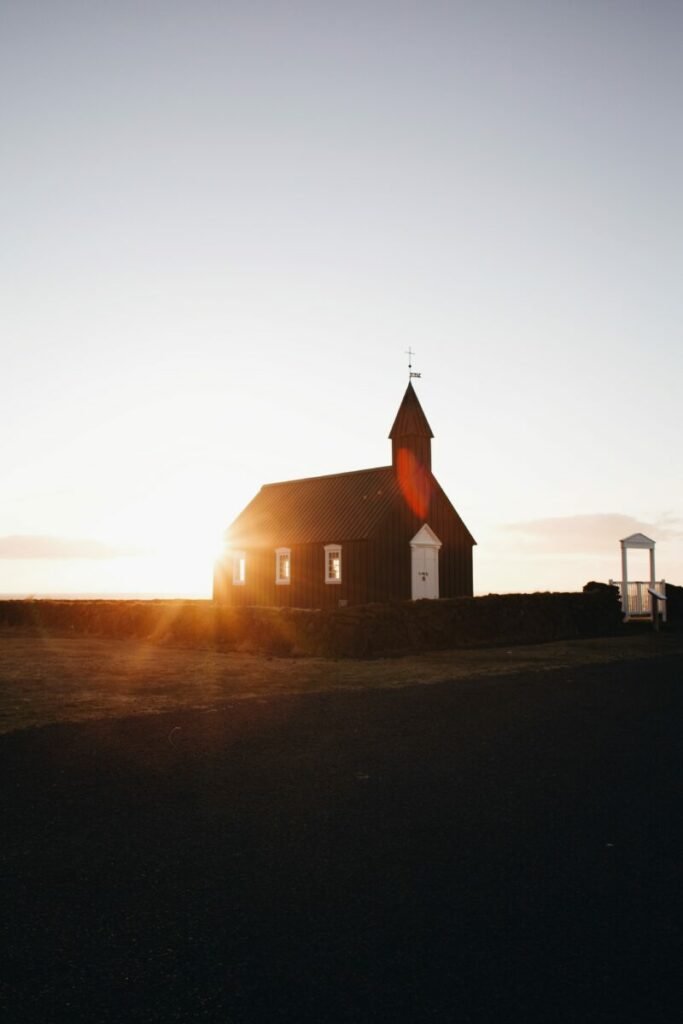 Photo of church with sun behind it