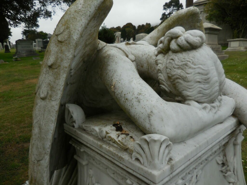 Photo of crying angel statue on tombstone