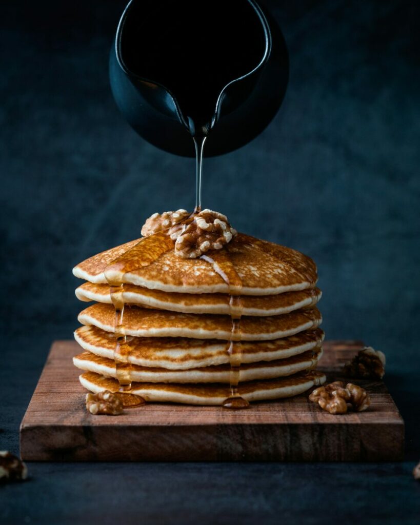 pancakes with black pitcher of syrup
