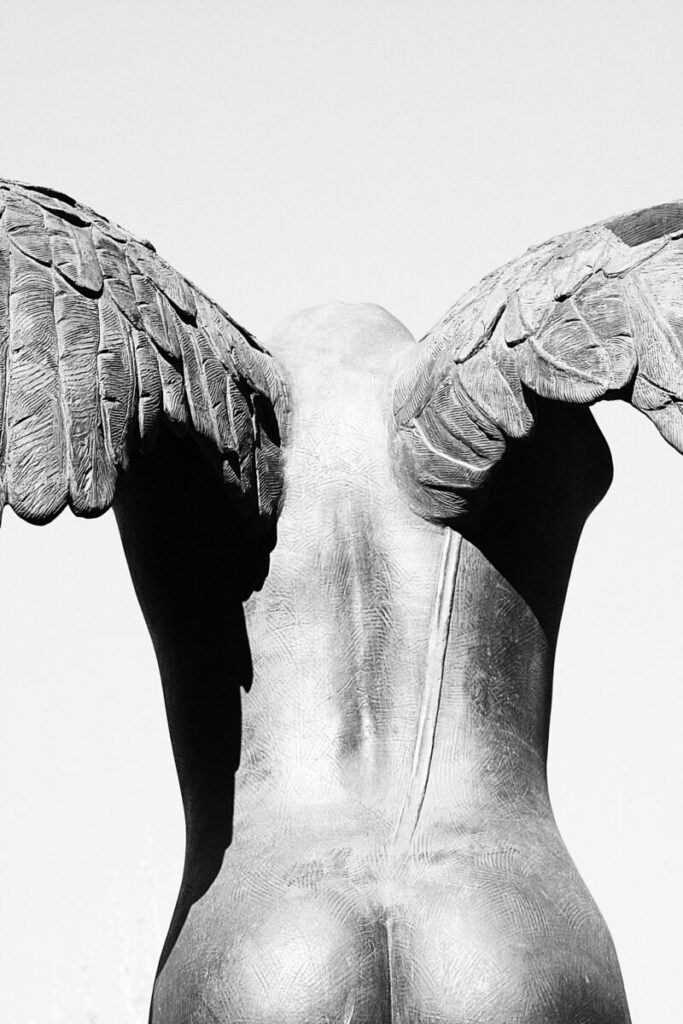 Photo of sculpture of angel, from back