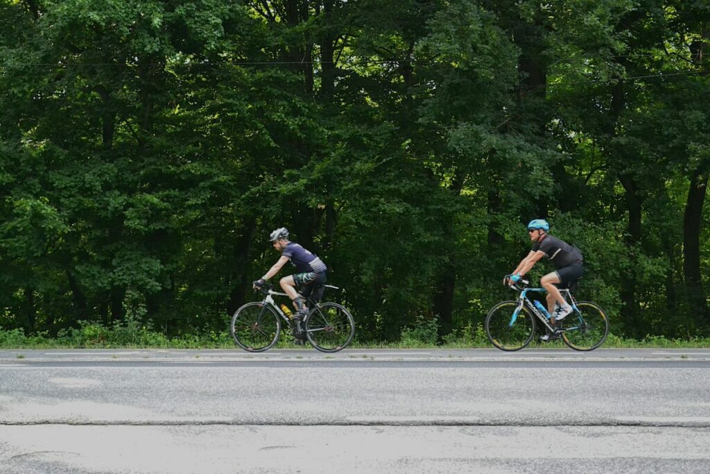 Photo of two men riding road bicycles