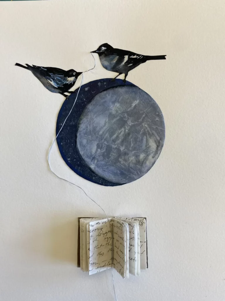 Moon with two black birds atop it, holding string connected to a journal below the moon