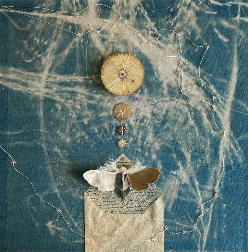 Mobile with large circle in middle, descending smaller circles below it, above a moth flying out of an envelope