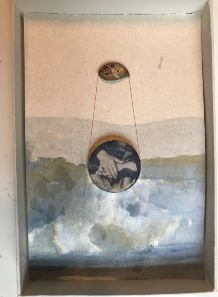 Mobile with eye shape holding up circle with hands on it, all in front of backgrounds painted to look like parting clouds
