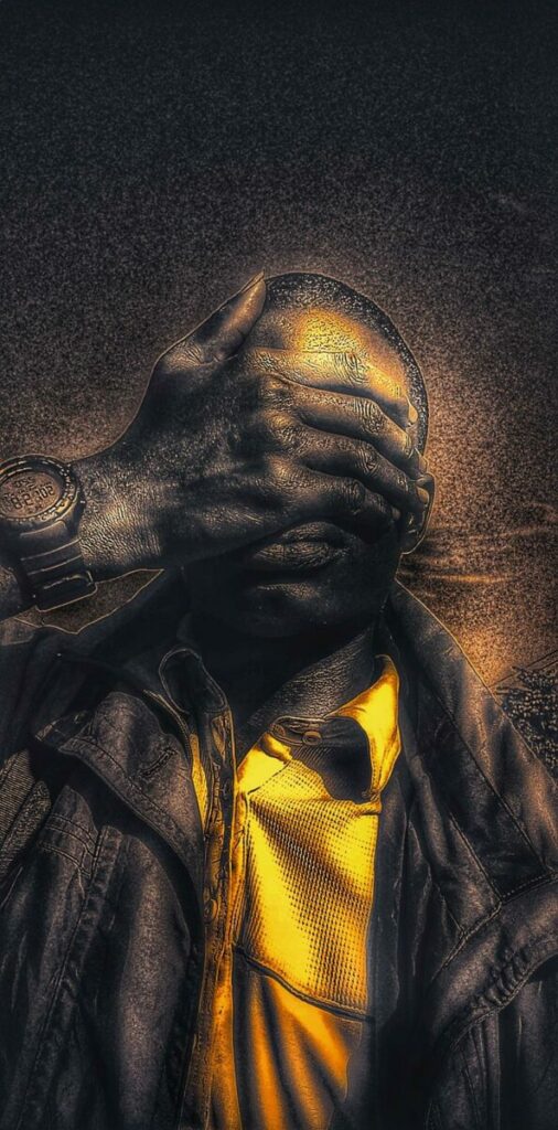 Digitally altered self portrait of artist covering his eyes with his hand