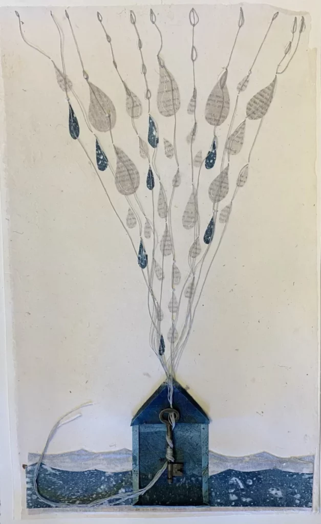 Pieces of tear drop shapes on strings, all connected to a key adhered to a house shape