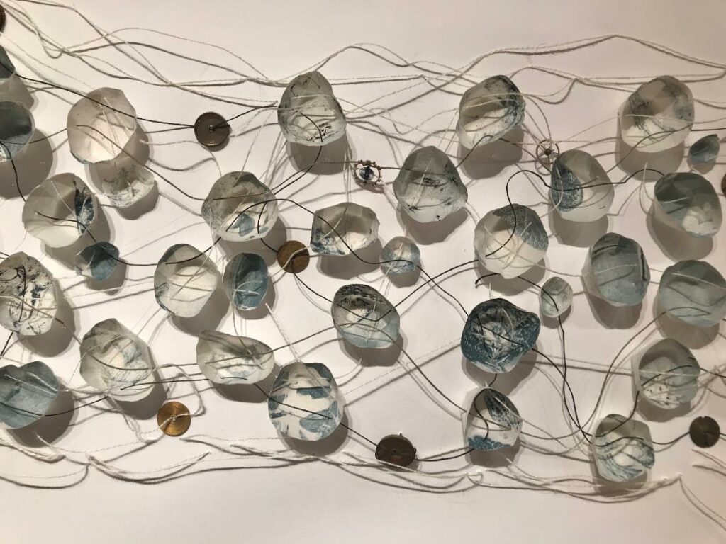 Wall mobile with lots of circular shapes hanging in it