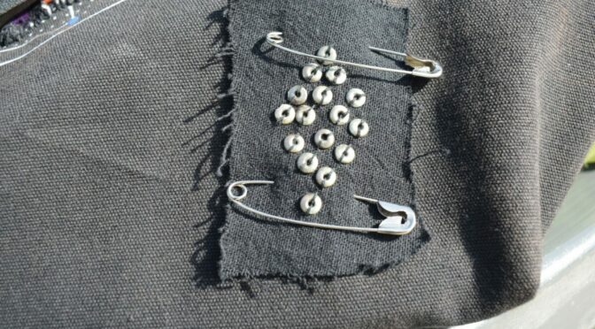 Photo of a patch held on with two safety pins